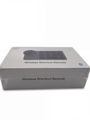 a white box with a wireless shortcut remote on top of it