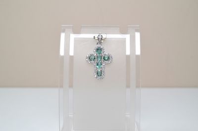 a small clear box with a cross on top of it