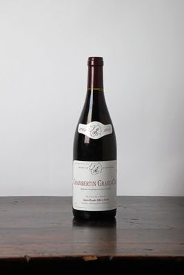 a bottle of wine sitting on a wooden table