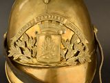 a gold helmet with a badge on it