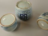 three blue and white vases sitting next to each other on a table
