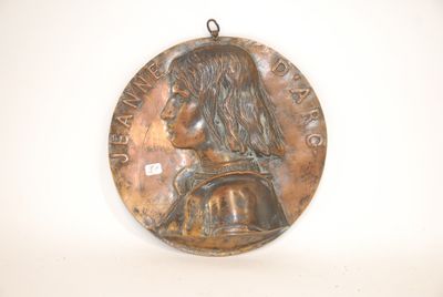 an image of a bronze medal with a woman ' s face on it