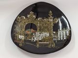 a decorative plate with a picture of a gate on it