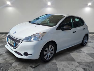 the small white car is parked in a large room