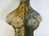 a sculpture of a woman that is standing on a table