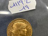 a close up of a gold coin with a note on it
