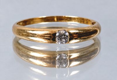 a close up of a gold ring with a diamond on top of it