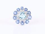 a close up of a ring with blue and white stones