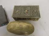 a small silver box and a small silver box on a table