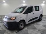 la camionnette blanche est garée sur un sol carrelé en damier