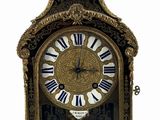 a gold clock with blue and white roman numerals on it