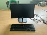 a computer monitor and keyboard on a desk