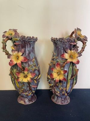two vases that have flowers on them on a table