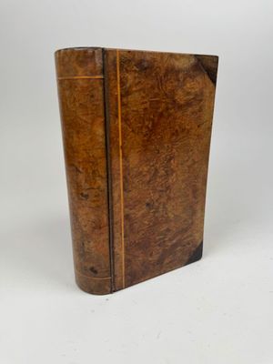 a close up of a book on a white surface with a white background