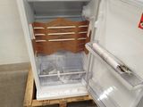 an open refrigerator that is sitting on a pallet