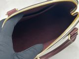 a hand that is holding a purse in it ' s left hand