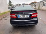 a black car parked on the side of the road