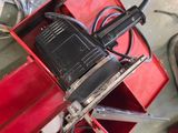 a red box with a radio on top of it next to a pair of scissors