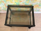 a glass table with a glass top on a tiled floor