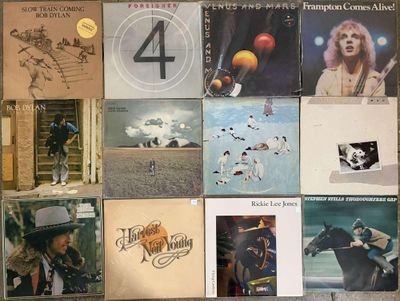 a lot of records on the wall of a room