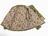a skirt with a camouflage pattern on it on a white surface