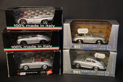 three boxed model cars are shown in boxes on a table