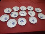 many plates on a red table with a red table cloth
