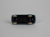 a small blue cell phone sitting on a white surface