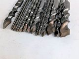 a pile of drill bits sitting on a table