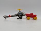 a toy helicopter and a toy firetruck on a white surface