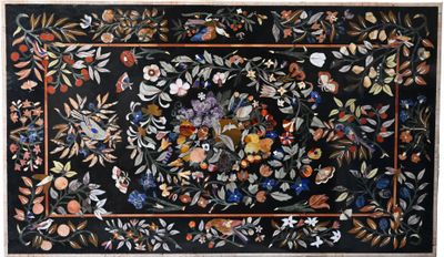 an image of a black rug with flowers and leaves on it
