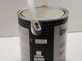 a can of paint sitting on a table with a handle