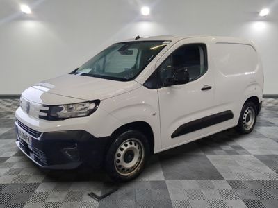 the white van is parked on a checkered tile floor