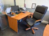 a desk with a chair and a computer on it