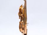 a bronze sculpture of a violin on a marble base