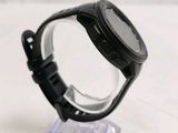 a close up of a watch on a clear stand