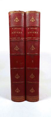two red books sitting on top of each other on a white surface