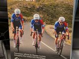 three bicyclists riding down the road on the road