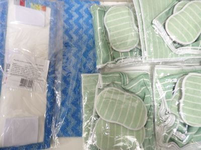 many pieces of green and white items in plastic bags