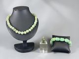 two pieces of jewelry on display on a table