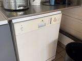 an image of a kitchen with a dishwasher and a trash can