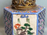 a small box with a painting on it sitting on a table
