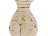a small vase with a design on it on a white surface
