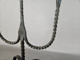 a pair of scissors hanging from a hook on a table
