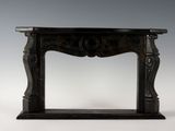 an antique black marble fireplace surround on a white background