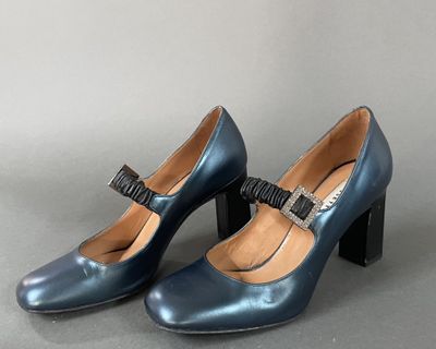 pair of women ' s blue heels with a bow on the heel