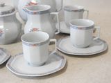 a lot of cups and saucers sitting on a table