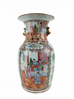 a vase with a painting on it sitting on a table