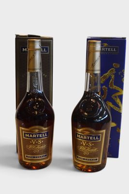 two bottles of whiskey sitting next to each other on top of a table