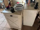 a white cabinet with a black and white hat on top of it